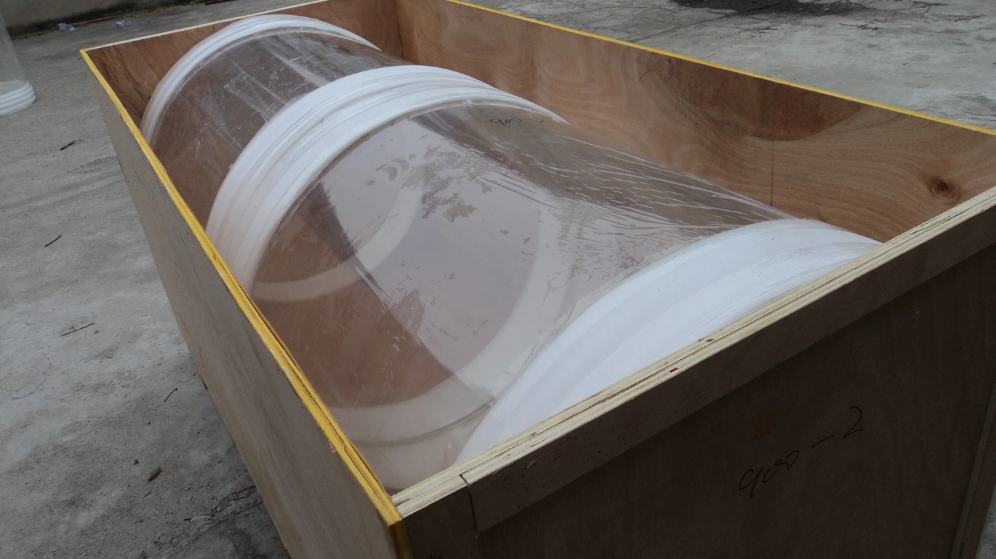A transparent acrylic cylinder protected inside a wooden export crate